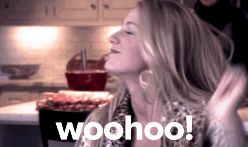 A Woman In A Kitchen With The Word Woohoo Written On It GIF