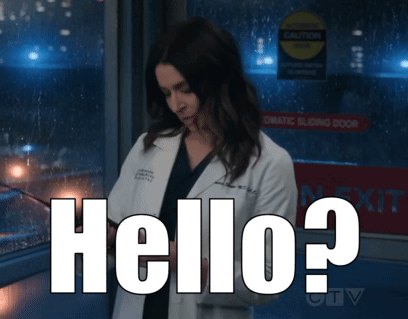 A Woman In A Lab Coat Is Standing In Front Of A Sign That Says " Automatic Sliding Door " GIF