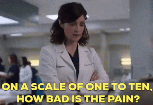 A Woman In A Lab Coat Is Talking About How Bad The Pain Is GIF