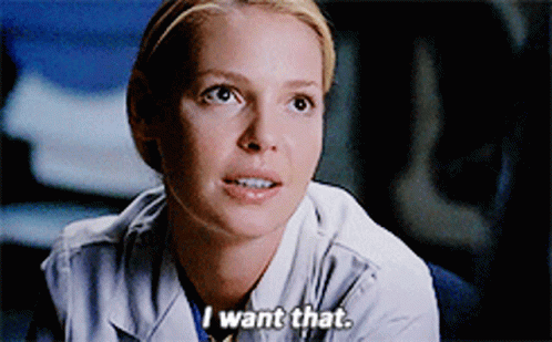 A Woman In A Lab Coat Says " I Want That " In A Close Up GIF