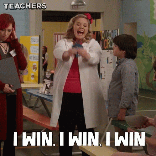 A Woman In A Lab Coat Says " I Win I Win I Win " In A Classroom GIF
