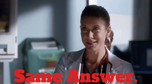 Woman In Lab Coat Smiling In Front Of Same Answer Sign GIF