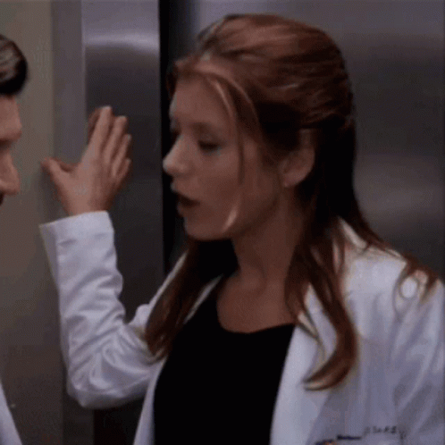 Woman In Lab Coat With AE On Chest GIF