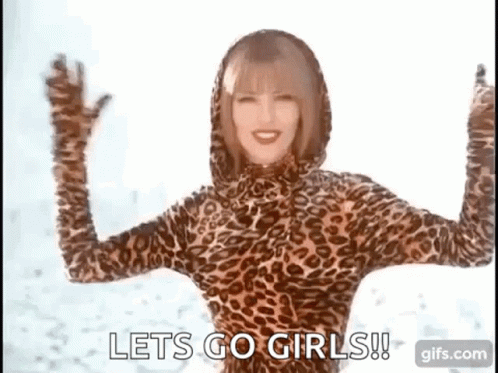 A Woman In A Leopard Print Bodysuit Is Dancing In The Snow . GIF