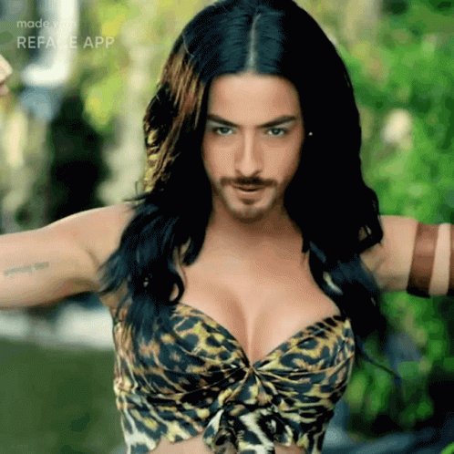 A Woman In A Leopard Print Bra Has A Beard GIF