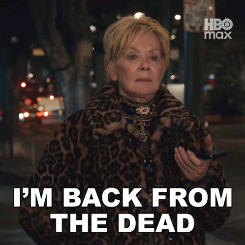 A Woman In A Leopard Print Coat Is Saying " I 'M Back From The Dead " GIF