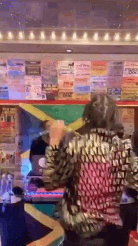 A Woman In A Leopard Print Shirt Is Standing In Front Of A Lottery Machine Holding A Yellow Ribbon . GIF