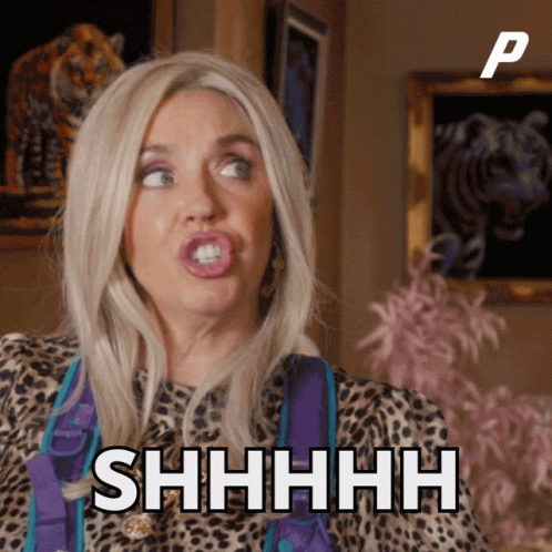 A Woman In A Leopard Print Shirt Says Shhhh In Front Of A Picture Of A Tiger GIF