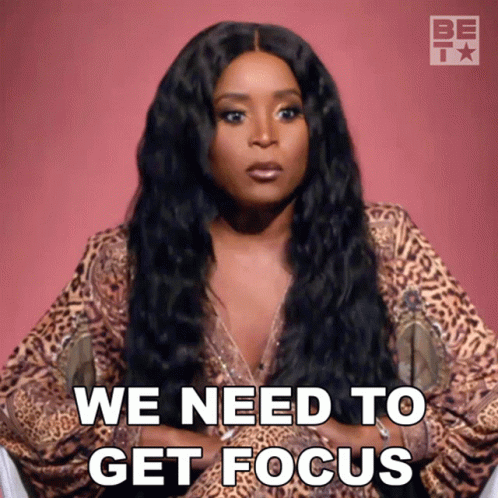 A Woman In A Leopard Print Top Says We Need To Get Focus GIF