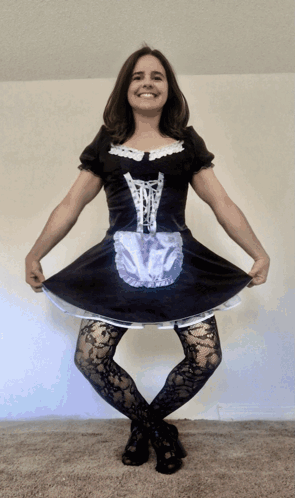 A Woman In A Maid Costume Is Smiling GIF