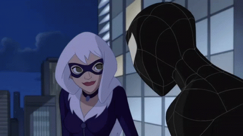 A Woman In A Mask Is Standing Next To A Man In A Suit GIF