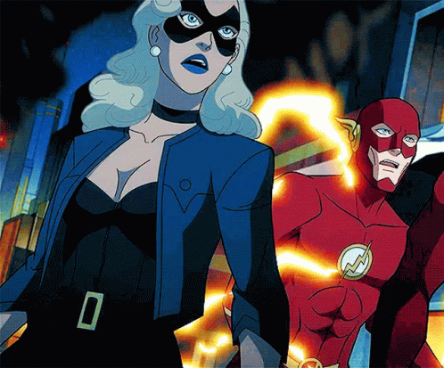 A Woman In A Mask Stands Next To A Man In A Flash Costume GIF