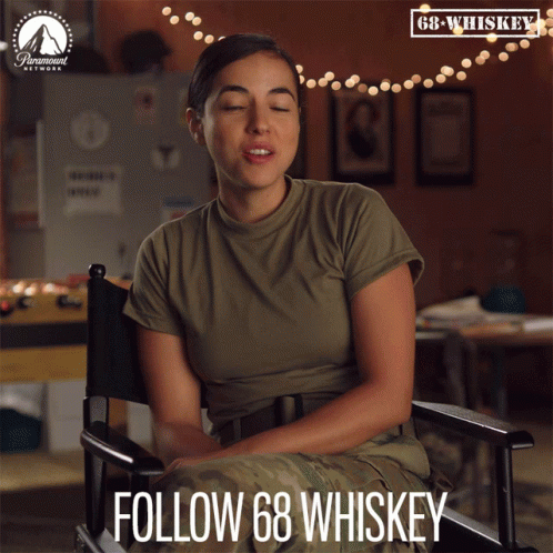 Woman In Military Uniform Sitting In Director's Chair GIF