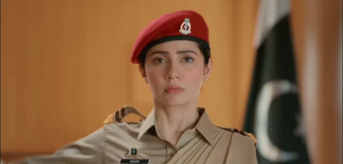 A Woman In A Military Uniform Is Wearing A Red Beret And Saluting . GIF