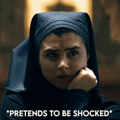 A Woman In A Nun 'S Outfit Is Pretending To Be Shocked With Her Hand On Her Chin GIF