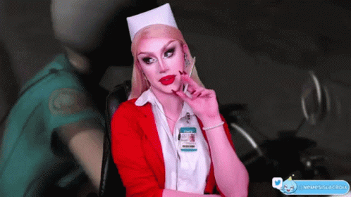 A Woman In A Nurse Costume Has A Badge That Says Staff On It GIF