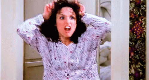 A Woman In A Pajama Shirt Is Holding Her Hair In Her Hands And Screaming . GIF