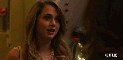 A Woman In A Pearl Necklace Is Pregnant And Says I 'M Pregnant . GIF