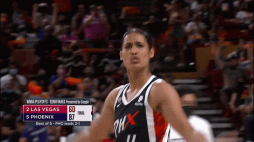 A Woman In A Phoenix Jersey Stands In Front Of A Crowd During A Game GIF