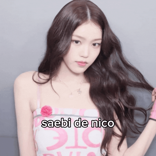 A Woman In A Pink And White Dress With The Words Saebi De Nico On The Bottom GIF