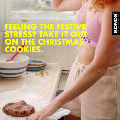A Woman In A Pink Bra And Shorts Is Baking Cookies With The Words Feeling The Festive Stress Take It Out On The Christma GIF