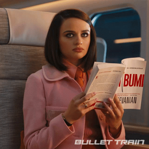 A Woman In A Pink Coat Is Reading A Book Called Bumi By Evanian GIF