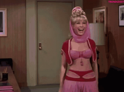 A Woman In A Pink Costume Is Dancing In A Living Room GIF