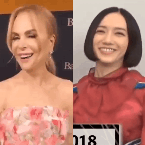 A Woman In A Pink Dress And A Woman In A Red Shirt Are Smiling And Laughing . GIF