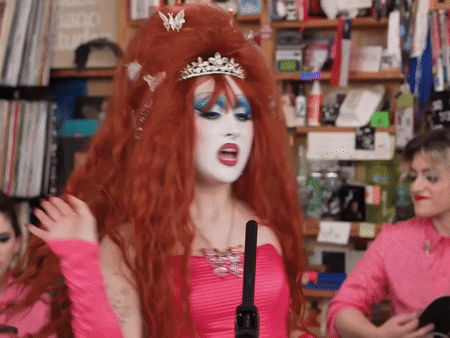 A Woman In A Pink Dress Has A Tiara On Her Head GIF