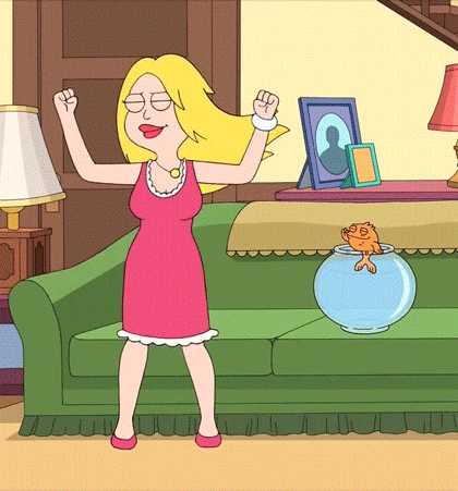 Woman In Pink Dress Dancing In Front Of Couch GIF