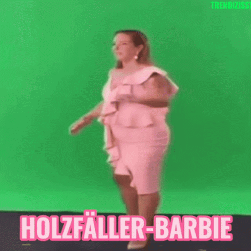 A Woman In A Pink Dress Is Dancing In Front Of A Green Screen With The Words Holzfaller-Barbie Written On It GIF