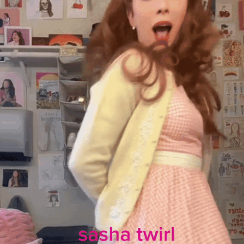 A Woman In A Pink Dress Is Dancing With The Words Sasha Twirl Written Below Her GIF