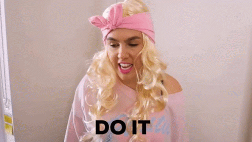 A Woman In A Pink Dress Is Holding A Shrek Toy And The Word Or Else Is On The Bottom GIF