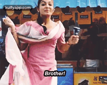 A Woman In A Pink Dress Is Holding An Ice Cream Cone And Dancing In Front Of An Ice Cream Stand . GIF