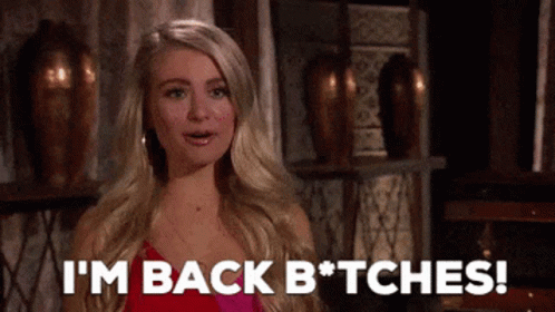 A Woman In A Pink Dress Is Saying I 'M Back Bitches GIF