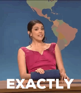A Woman In A Pink Dress Is Sitting At A Desk With The Words Exactly Written On It . GIF