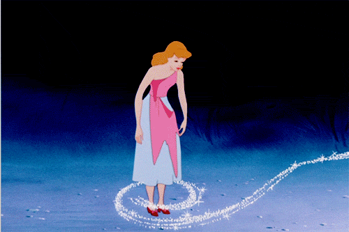 A Woman In A Pink Dress Is Standing In A Circle Of Glitter GIF