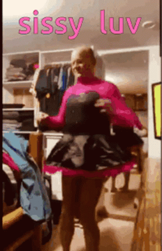 A Woman In A Pink Dress Is Standing In A Closet With The Words Sissy Luv On The Bottom GIF