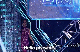A Woman In A Pink Dress Is Standing In Front Of A Sign That Says Hello Peasants GIF