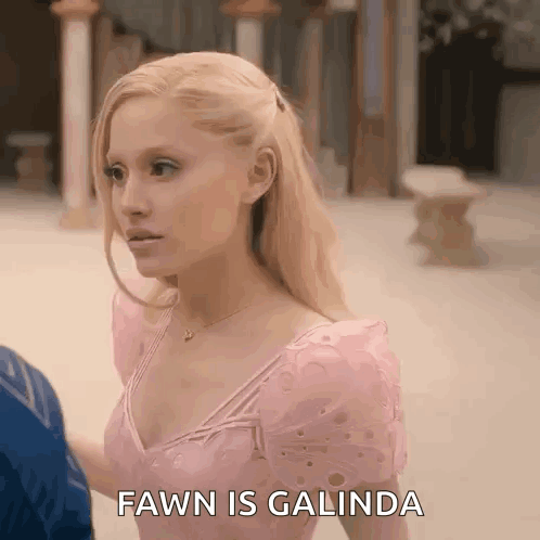 A Woman In A Pink Dress Is Standing Next To A Man And Says Fawn Is Galinda . GIF