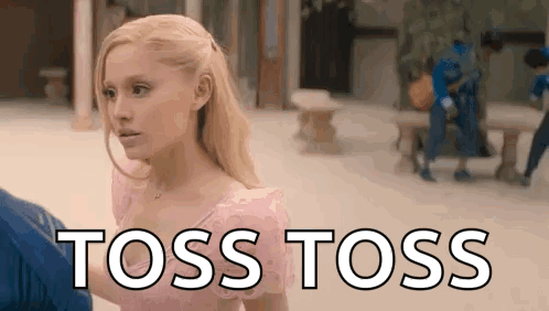 A Woman In A Pink Dress Is Standing Next To A Man In A Blue Shirt And Says `` Toss Toss '' . GIF