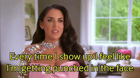 A Woman In A Pink Dress Is Talking About Getting Punched In The Face GIF