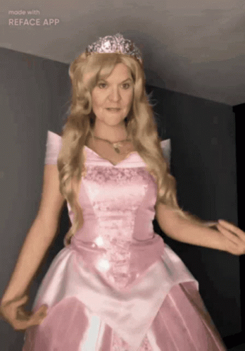 A Woman In A Pink Dress With A Tiara On Her Head Is Made With The Reface App GIF