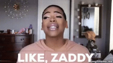 A Woman In A Pink Hoodie Is Making A Face And Saying Like Zaddy . GIF