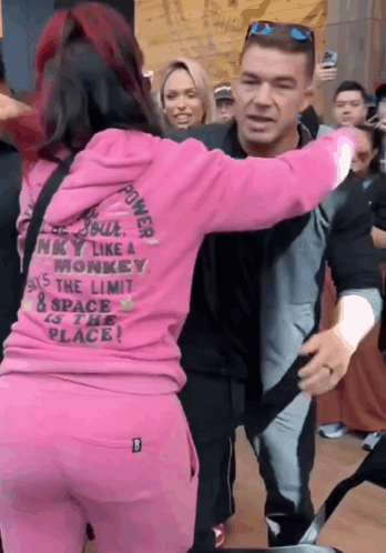 A Woman In A Pink Hoodie That Says Power On It GIF