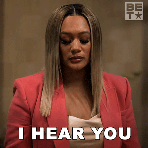A Woman In A Pink Jacket Is Saying I Hear You GIF