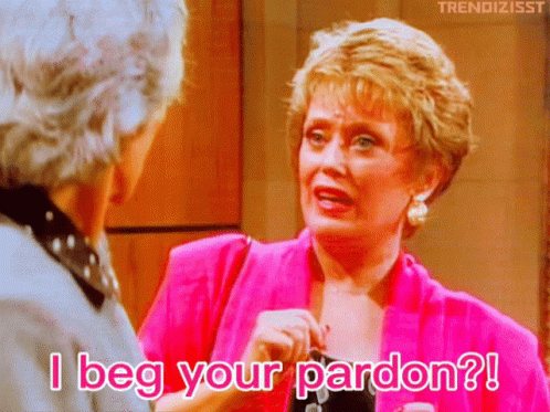 A Woman In A Pink Jacket Says " I Beg Your Pardon " To Another Woman GIF