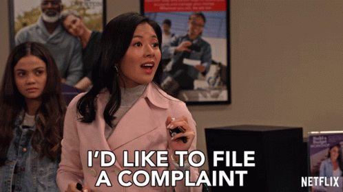 A Woman In A Pink Jacket Says " I 'D Like To File A Complaint " GIF