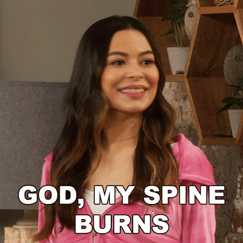 A Woman In A Pink Jacket With The Words God My Spine Burns Below Her GIF