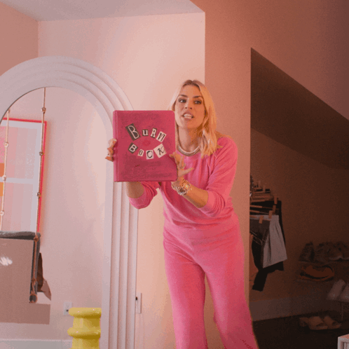 A Woman In A Pink Outfit Holds A Burn Book GIF